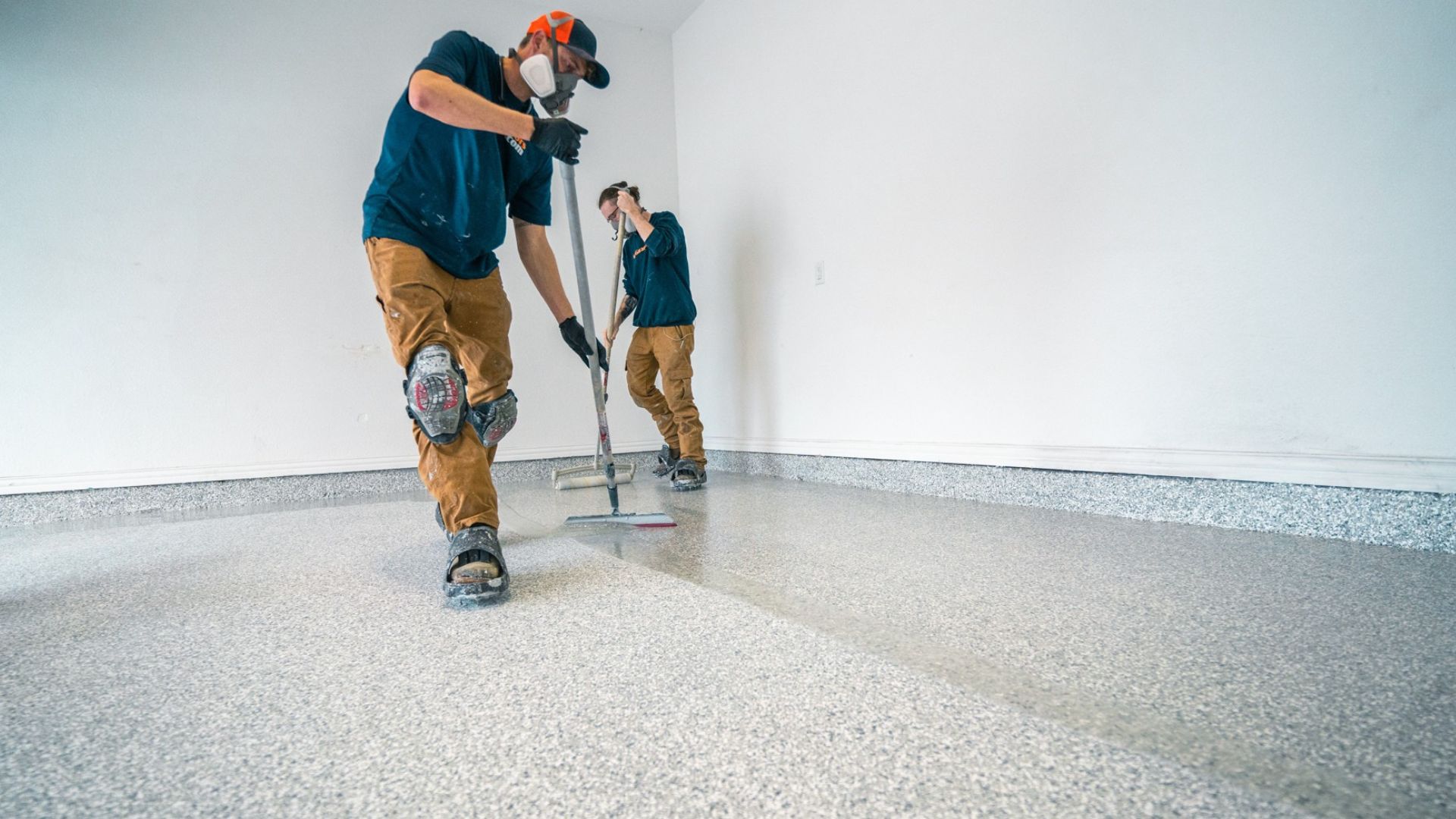 Mygaragefloors.com Installers Applying a Polyaspartic Coating for a Premium Garage Floor Finish. - Mygaragefloorscom Garage Floor Coating Installation
