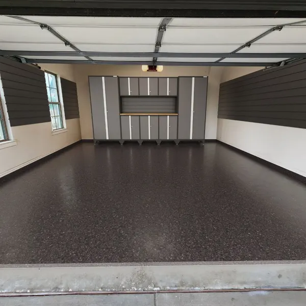 The same garage after coating, with a Carbon dark charcoal full flake polyaspartic floor by MyGarageFloors.com