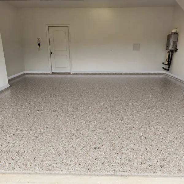 The same garage after coating, with a Creekbed tan and gray full flake polyaspartic floor by MyGarageFloors.com